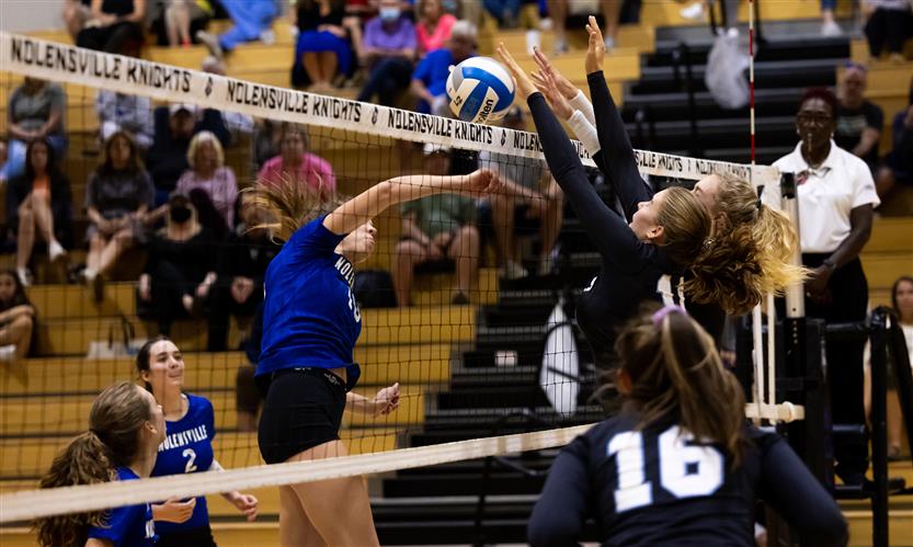 High school students play volleyball